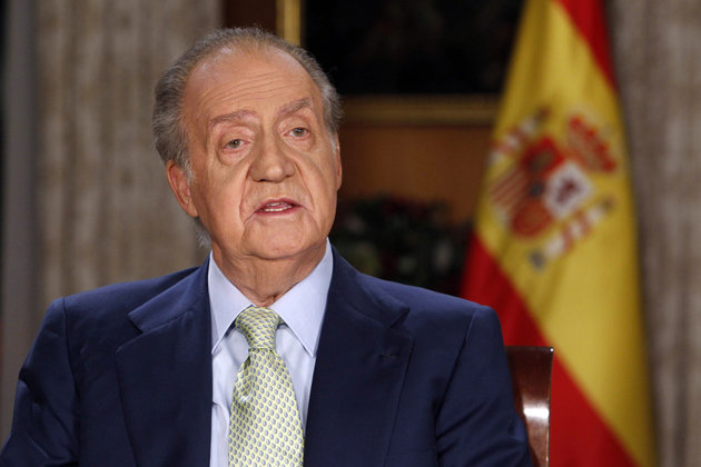 Spanish King Juan Carlos speaks during his traditional Christmas message at Zarzuela Palace in Madrid